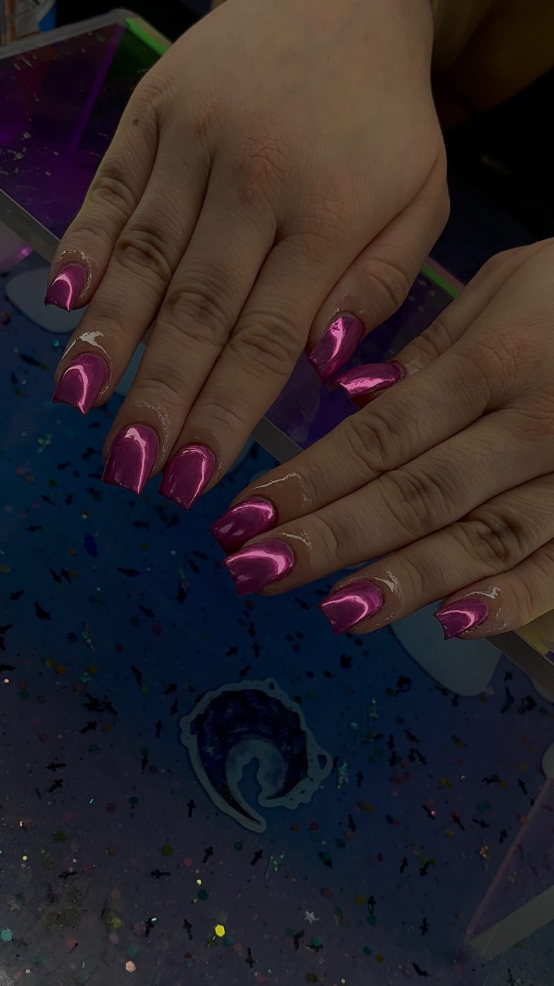 Lia nail art with bright pink glossy nails and blue accent nails.