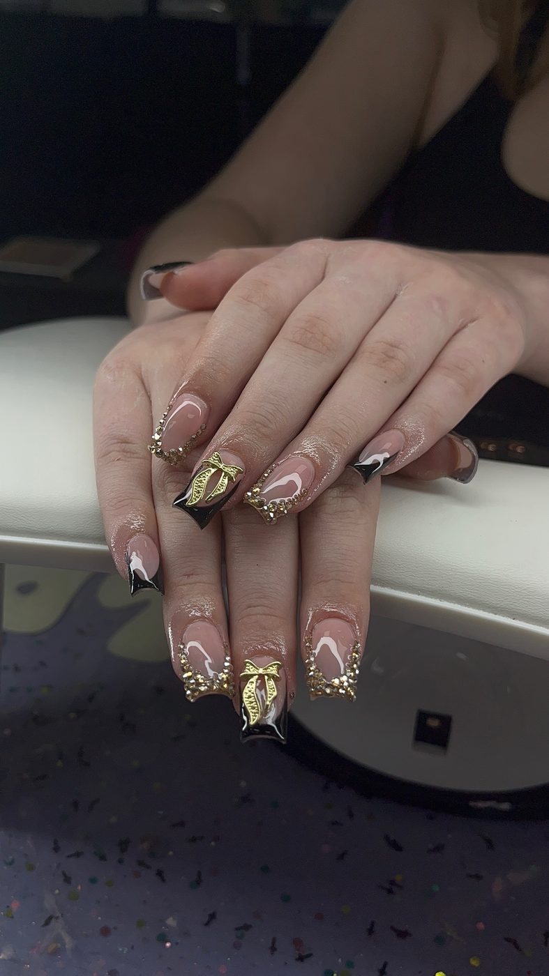 Lia nail art with black, gold, and nude alternative details with metallic accents.